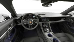 Interior view showing the steering wheel and dashboard of Taycan 4