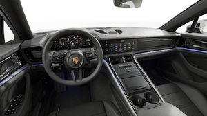 Interior view showing the steering wheel and dashboard of Panamera 4