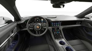 Interior view showing the steering wheel and dashboard of Taycan