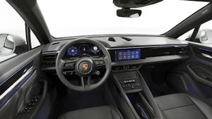 Interior view showing the steering wheel and dashboard of Macan