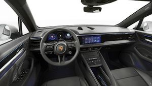 Interior view showing the steering wheel and dashboard of Macan 4