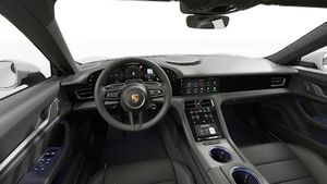 Interior view showing the steering wheel and dashboard of Taycan