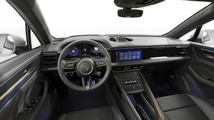 Interior view showing the steering wheel and dashboard of Macan Turbo