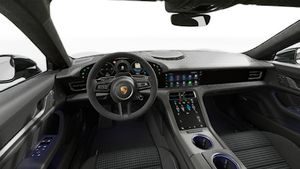Interior view showing the steering wheel and dashboard of Taycan Sport Turismo Black Edition