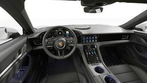Interior view showing the steering wheel and dashboard of Taycan