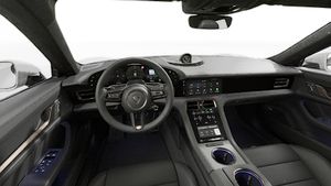 Interior view showing the steering wheel and dashboard of Taycan Turbo