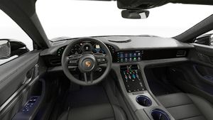 Interior view showing the steering wheel and dashboard of Taycan 4 Black Edition