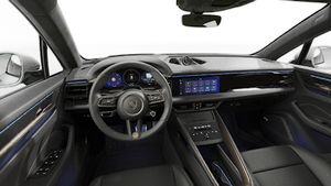 Interior view showing the steering wheel and dashboard of Macan Turbo