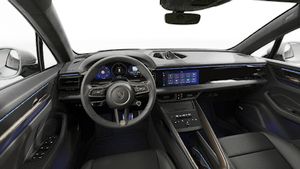 Interior view showing the steering wheel and dashboard of Macan Turbo