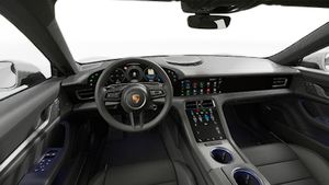 Interior view showing the steering wheel and dashboard of Taycan 4