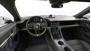 Interior view showing the steering wheel and dashboard of Taycan
