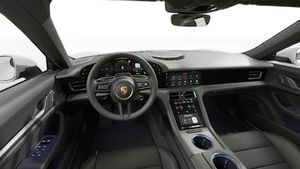 Interior view showing the steering wheel and dashboard of Taycan