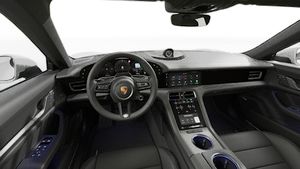 Interior view showing the steering wheel and dashboard of Taycan 4