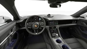Interior view showing the steering wheel and dashboard of Taycan