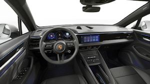 Interior view showing the steering wheel and dashboard of Macan