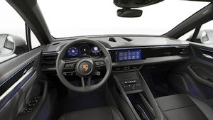 Interior view showing the steering wheel and dashboard of Macan 4