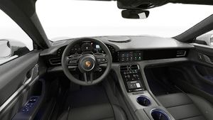 Interior view showing the steering wheel and dashboard of Taycan 4