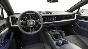 Interior view showing the steering wheel and dashboard of Cayenne Coupé