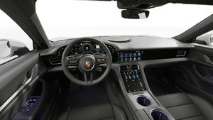 Interior view showing the steering wheel and dashboard of Taycan